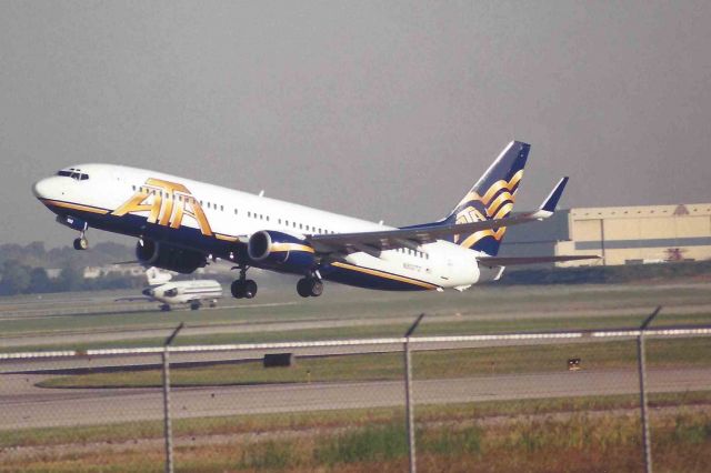 Boeing 737-800 (N302TZ) - Lifting off of 23-L at KIND. Company 727 and mx hgr in the background.