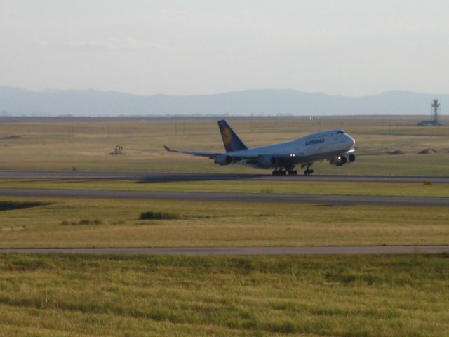 Boeing 747-200 (D-ABTC) - Taking off to the north at DIA.