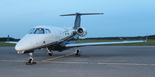 Embraer Phenom 300 (N376FX) - A Flexjet 2018 model Embraer EMB-505 Phenom 300 on the ramp at H.L. Sonny Callahan Airport, Fairhope, AL - June 20, 2018. Shot at sundown with a flash and the Canon T6 in Portrait Mode.