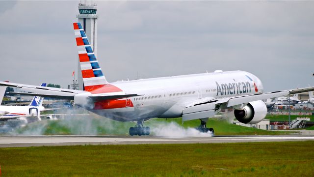 BOEING 777-300 (N729AN) - BOE313 from KARA makes tire smoke on landing Rwy 16R on 5/6/14. (LN:1200 / cn 33127).