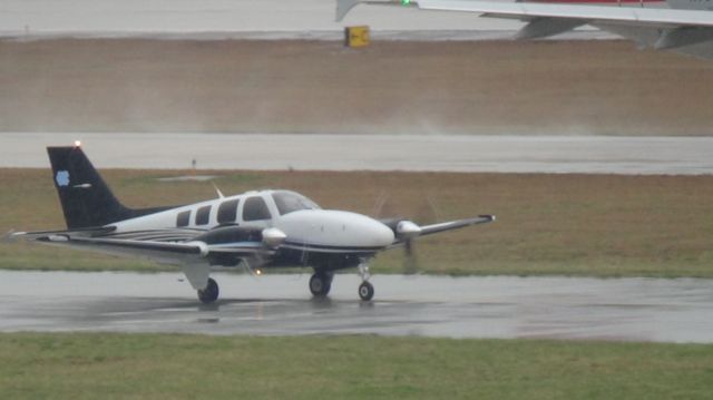 Beechcraft Baron (58) (N219CH) - N766US taxing out to runway 23R.and N219CH heading to the FBO that blocks the view :-(.  Taken March 19, 2015.