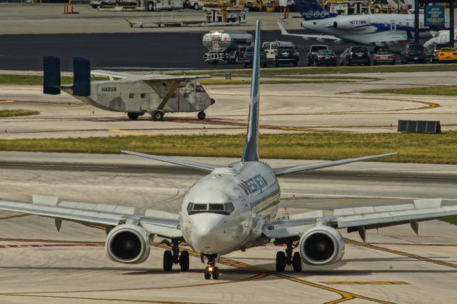 Boeing 737-700 (C-FWSI) - Taxi after landing with N80GB Shorts SC.7 crossing.