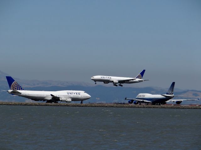 Boeing 747-400 (N116UA) - Triple United heavies from all around the globe.