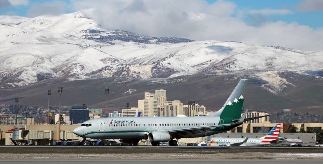 Boeing 737-800 (N916NN) - AAL's Reno Air heritage livery special schemebird (N916NN) is down and slowing as it passes in front of the downtown Reno city skyline after landing on runway 16R to complete a DFW-RNO trip.