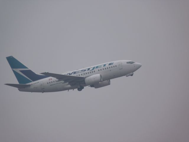 Boeing 737-700 (C-GWSB) - taking off of rwy#32, with a low ceiling