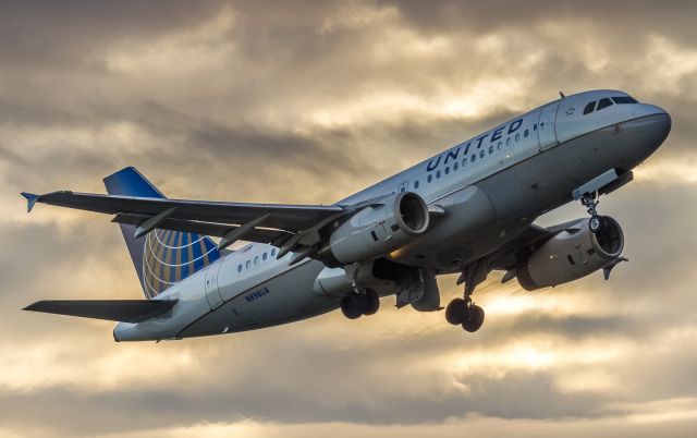 Airbus A319 (N898UA) - A United A319 climbs off runway 23 at sunrise bound for Chicago