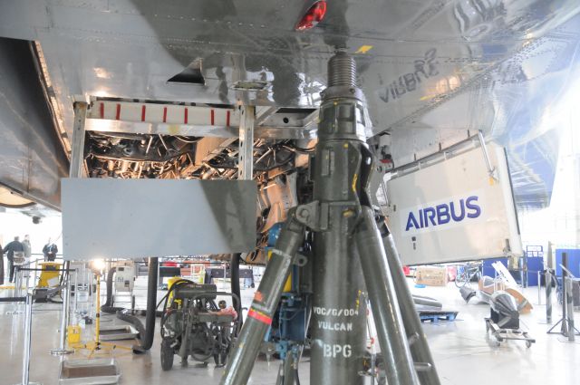 G-VLCN — - Lifting Jacks being placed in preparation for lifting the Vulcan off the floor to test the Main Under Carriage operation. This is Port front, one of 4 jacks used.to the left is the under wing Airbrake.