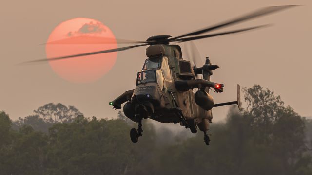 Eurocopter EC-635 (A38022) - Eurocopter Tiger Armed Reconnaissance Helicopter of 1st Aviation Regiment takes off into a bushfire sky with the smoke taming the setting sun.