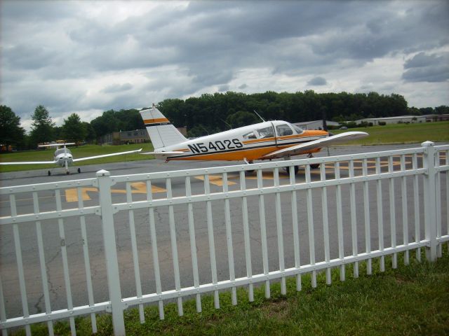 Piper Cherokee (N5402S) - Passing by on a cloudy day to takeoff on runway 5 at the Doylestown Airport in Pennsylvania.