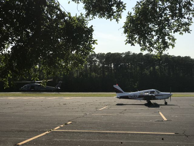 Piper Cherokee (N2114F) - N2114F parked while helicopter does touch-and-goes on the runway at KFFA.