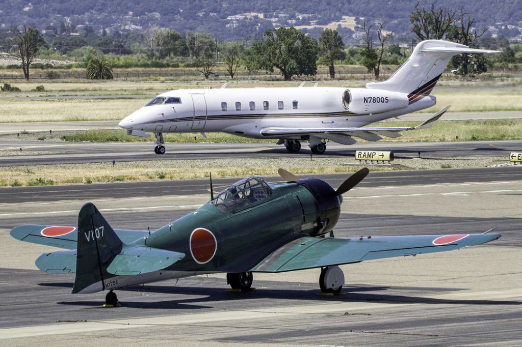 North American T-6 Texan (N7754) - CCF T6 Harvard MK IV TORA! TORA! TORA! movie replica Zero with N780QS Bombardier BD-100-1A10 taxiing by.