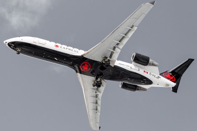 Canadair Regional Jet CRJ-200 (C-FEJA) - A Jazz Air CRJ-200 overhead to land at Montreal.