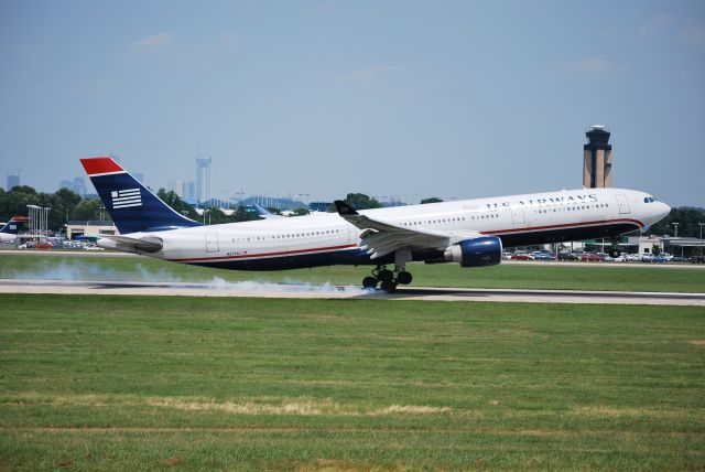 Airbus A330-300 (N275AY) - Touching down on runway 18C - 6/28/09