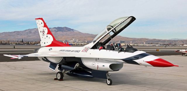 Lockheed F-16 Fighting Falcon (91-0467) - A USAF "Thunderbirds" Demo Team F-16D, 91-0467, the Fighting Falcon that holds the call sign "Thunderbird 8," is captured in this click as it sits on the Atlantic Aviation ramp at Reno Tahoe International during a short visit. A portion of the downtown Reno skyline is visible in the background.