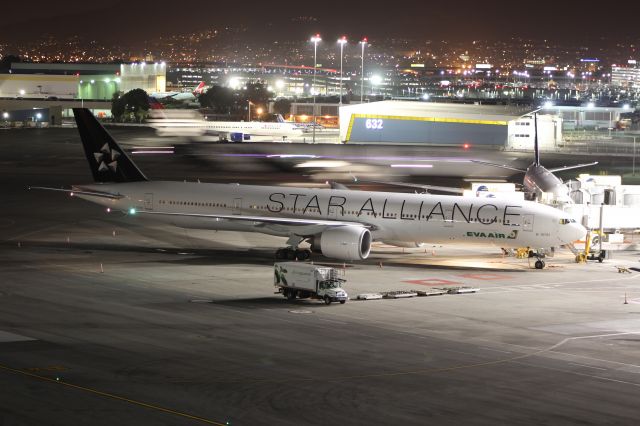 Boeing 747-400 (B-16701) - Loading up while ZK-OKR taxis by