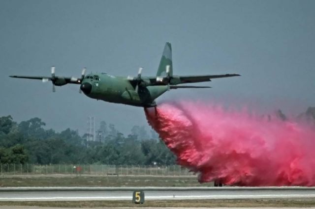 Lockheed C-130 Hercules — - C-130E of the 146th Tactical Airlift Wing performs a MAFFS demonstration at the NAS Pt. Mugu Airshow on October 13, 1990.