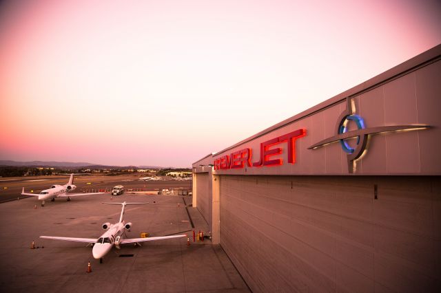 — — - Premier Jet at sunset