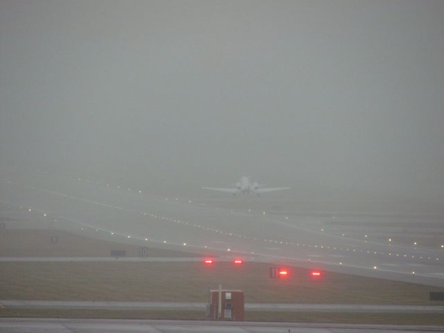 Cessna Citation Excel/XLS (N70TH) - A Cessna Citation Excel taking off into the fog blanketed sky