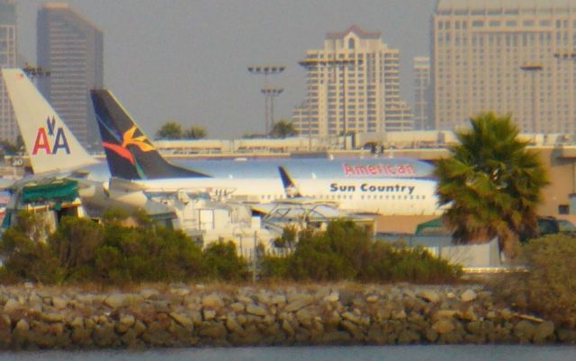 Boeing 737-700 — - First time Ive seen this. Sun Country with an old Aloha plane. This was about as good of a shot as I could get, as they were starting to turn during pushback. It flew as SCX404, 7/4/08