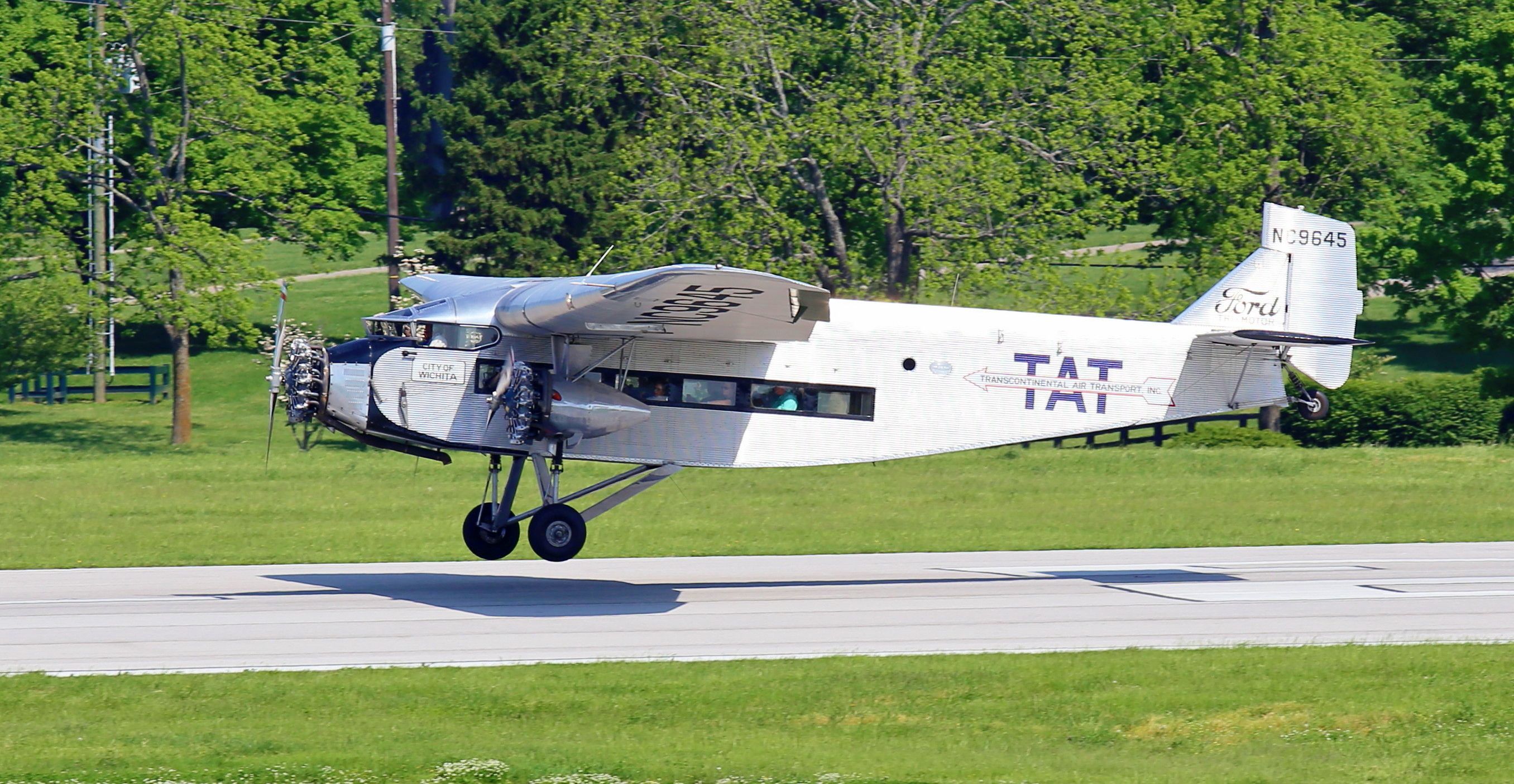 NC9645 — - Transcontinental Air Transport TAT 1929 Ford Tri-Motor inches away from touchdown on runway 22 at KLEX Lexingtons Bluegrass Airport.