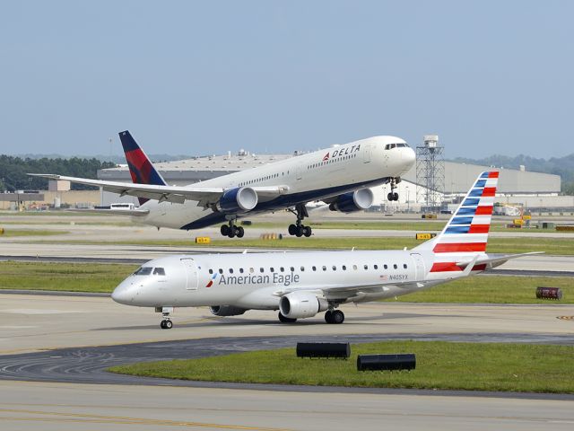 Embraer 170/175 (N405YX) - These are rare opportunities. The American Eagle ERJ-175 was taxing to the gate. All of a sudden, the B767-400 is coming down the runway very fast. I barely had enough time to capture the moment.   