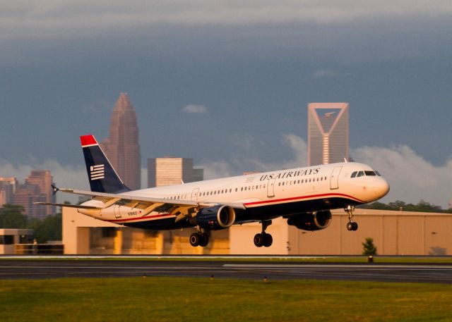 Airbus A321 (N184US) - With downtown Charlotte in the background, this big Airbus 321 lands on runway 5 just after a thunderstorm passed over the area. Charlotte, North Carolina USA, 27 May 2011