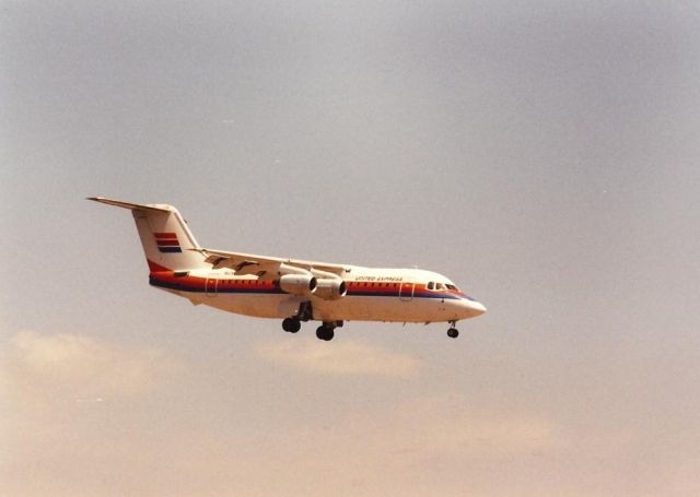 — — - United Express BAe 146 landing at Santa Ana in the late 1980s