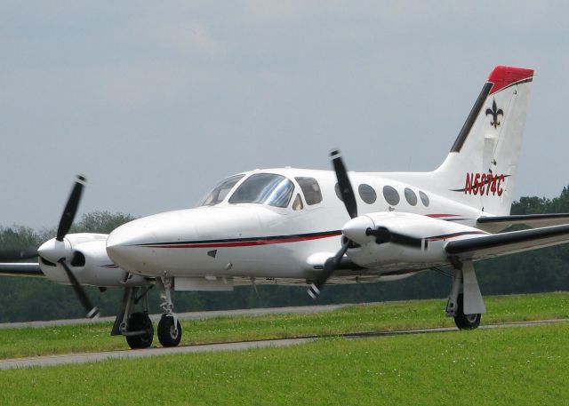 Cessna 421 (N5874C) - Taxiing to runway 14 at the Shreveport Downtown airport. The fleur-de-lis on the tail makes me think that either someone is a N.O. Saints fan or they just like the fleur-de-lis. Nice looking aircraft anyway.