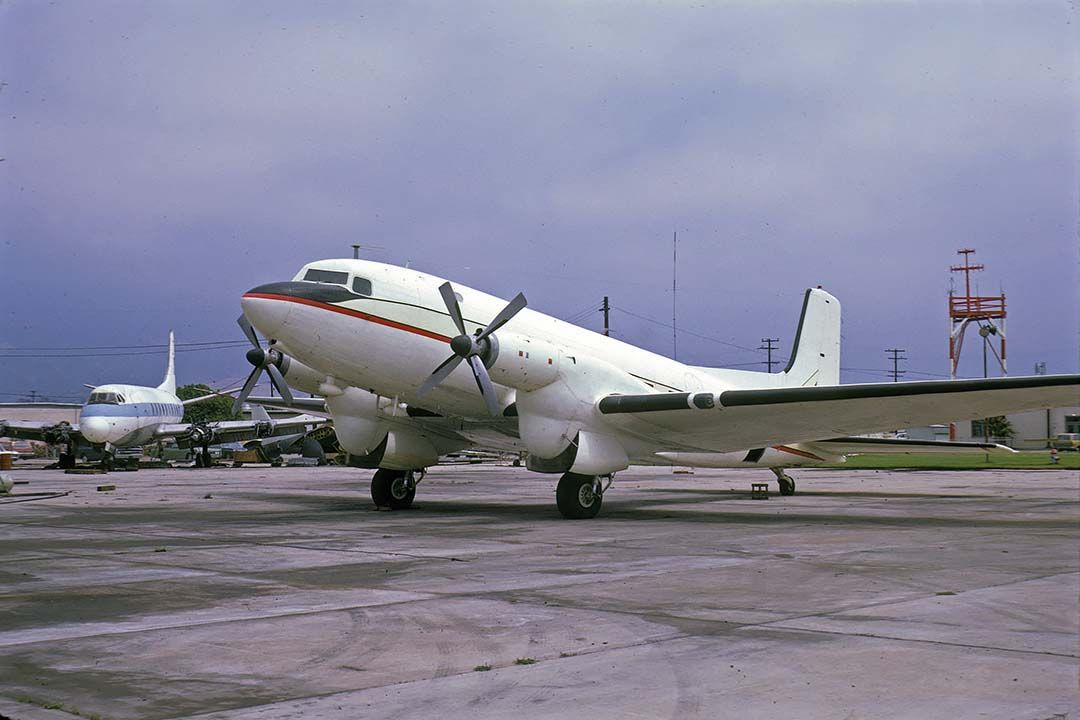 Douglas DC-3 (N156WC) - Super-Turbo-Three N156WC at the Santa Barbara Airport on June 12, 1974. Its Douglas airframe ID was 43193. The Super DC-3 had larger wings and tail surfaces than the DC-3, and its main landing gear were fully enclosed. Although very few Super DC-3s had been purchased by the airlines, the Navy and Marine Corps were retiring several R4D-8s about that time. Note the Viscount engine donor parked at the left.