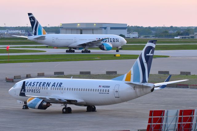 Boeing 777-200 (N825KW) - Two for one! EAL B-737-3H4 N629SW while queen mother ship taxi's to the IAB ramp. At sunset, 05-06-25
