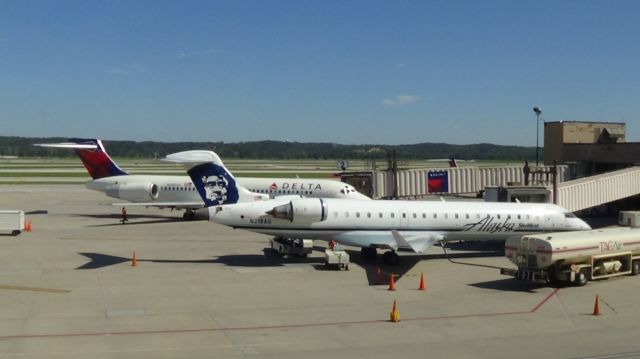 Canadair Regional Jet CRJ-700 (N218AG) - An Alaska CRJ-700 siting at gate A1, and a Delta 717-200 sitting at gate A2.   Taken September 11, 2015. 