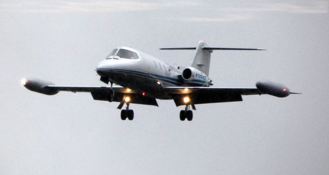 Learjet 25 (N10VG) - On final in the rain is a 1973 Gates Learjet 25B in the Spring of 2019. From the car window opposite side of where the rain is coming down.  