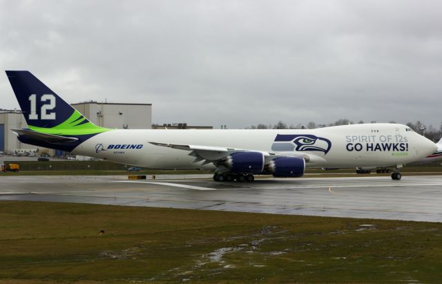 BOEING 747-8 (N770BA) - Boeing shows off Seattle Seahawks Superbowl run pride by painting N770BA in team colors.This is the first time it took to the air after being painted.