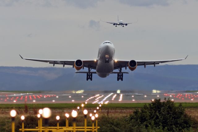 Airbus A330-200 (OY-VKF) - TCX824 off to Los Angeles as TCX2443 from Mahon gets ready to land in the background.