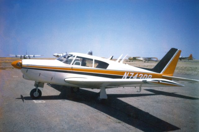 Piper PA-24 Comanche (N7430P) - Our old plane, mid-1970s at Prescott. Shortly after the black and gold factory paint job was updated with orange for better visibility after my dad had a close encounter in the crowded airspace over Los Angeles. Note the Forest Service B-17 slurry bomber in the background.