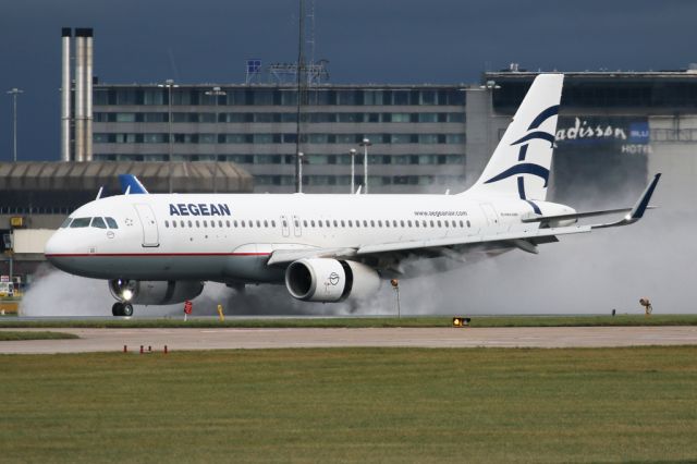 Airbus A320 (SX-DNC) - AEE638 arriving from Athens and clearing some water from the runway.