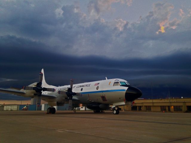 Lockheed P-3 Orion (NOAA43) - NOAA 43, P-3, on Salina ramp with a thunder storm cell approaching from behind. Nicholas Evenson Photography