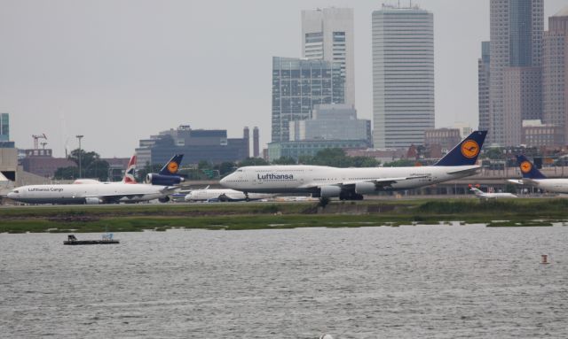 BOEING 747-8 (D-ABYA) - Lufthansa Love - Lufthansa B747-8 departing on 15, while Cargo MD11 taxis along side and A346 in back with mechanical issues.