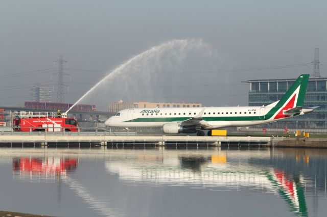 Airbus A319 (EI-RNB) - An Alitalia Embraer E-190 receives a water cannon salute, as it commences a new service to London City Airport.