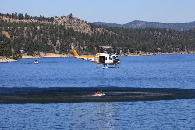 N388M — - USDA Forest Service UH-1H helicopter scooping water from Canyon Ferry Lake, MT. to fight the Matt Staff Road wildfire.