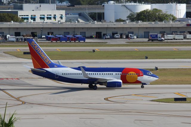 Boeing 737-700 (N230WN) - Southwest Airlines (WN) N230WN B737-7H4 [cn34592] in Colorado One liverybr /Fort Lauderdale (FLL). Southwest Airlines flight WN3899 taxis to the gate after arrival from Chicago Midway (MDW). The aircraft was painted in 2012 with this special ‘Colorado One’ livery based on the Colorado state flag. Since 1988 Southwest Airlines have painted selected aircraft in special liveries reflecting the images of principal US states SWA serves, destination partners or aspects of the SWA’s history.  This airframe is also the 5,000th Boeing 737 built. br /Taken from Terminal 1 car park roof level br /br /2018 04 07br /a rel=nofollow href=http://alphayankee.smugmug.com/Airlines-and-Airliners-Portfolio/Airlines/AmericasAirlines/Southwest-Airlines-WNhttps://alphayankee.smugmug.com/Airlines-and-Airliners-Portfolio/Airlines/AmericasAirlines/Southwest-Airlines-WN/a