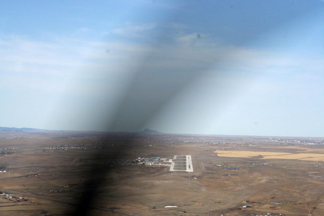 Mooney M-20 (N5675Q) - on approach to 32 at 5500 ft. on the afternoon (about 3pm) on 3/28/10.  Photo by Julie K. Bartley, Canon Rebel XT.