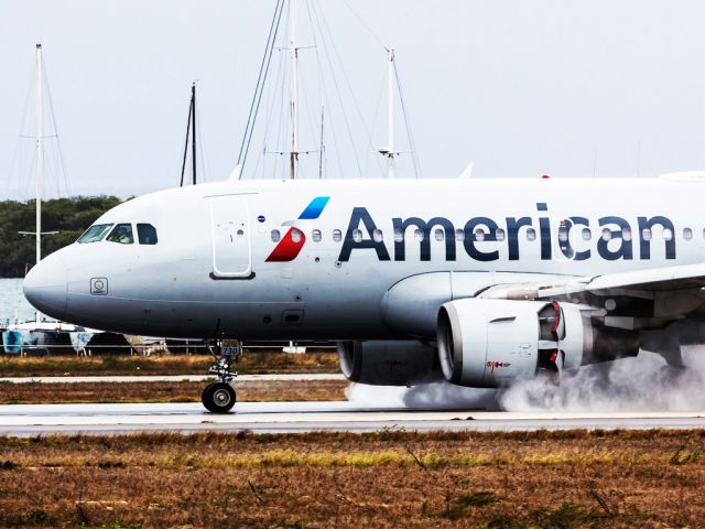 Airbus A319 (N730US) - Runway dryer.