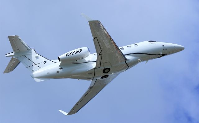 Embraer Phenom 300 (N323KP) - N323KP climbing out of St maarten.