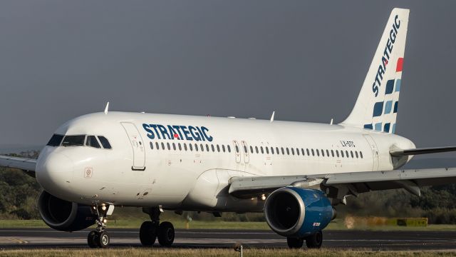 Airbus A320 (LX-STC) - Defunct, Strategic Air, A320, on lease, taxies to the terminal after touching down at Manchester Airport.