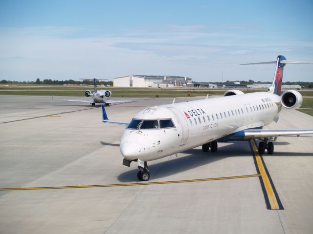 Canadair Regional Jet CRJ-700 (N691CA) - A shot through the parking lot fence.