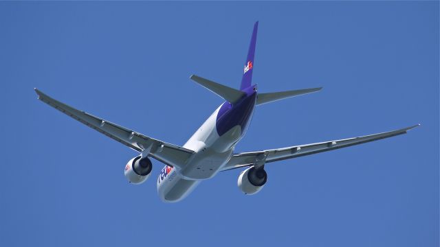 Boeing 777-200 (N890FD) - FDX9077 climbs into a clear blue sky from runway 34L to begin its delivery flight to KMEM on 8/1/12.br /The aircraft is a B777-FS2, LN:1033, c/n 41439.