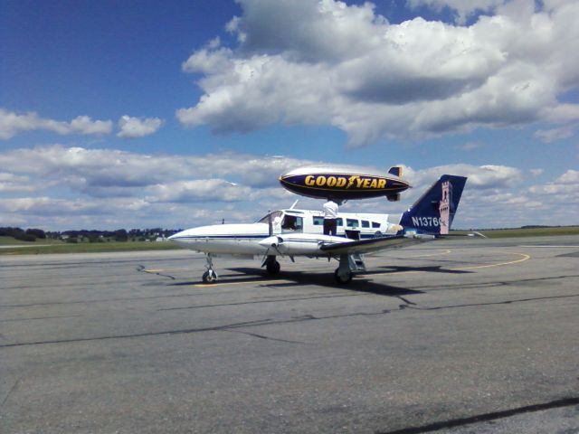 Cessna 402 (KAP409) - GOODYEAR blimp did a fly by. Descended to about 20-30 feet for length of rw.  Then made a steep ascent that looked like \.  No exaggeration!