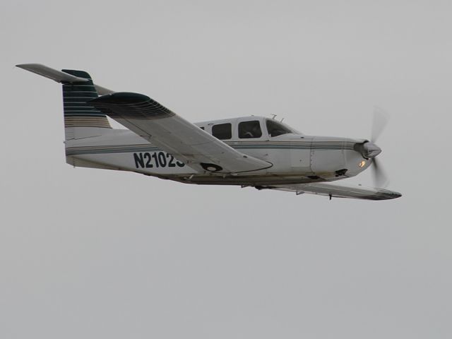 Piper Saratoga (N2102S) - Low approach on an overcast day in Longmont.