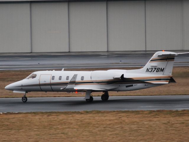 Learjet 31 (N37BM) - Taking off on runway 20 in light drizzle at KJQF - 2/18/09